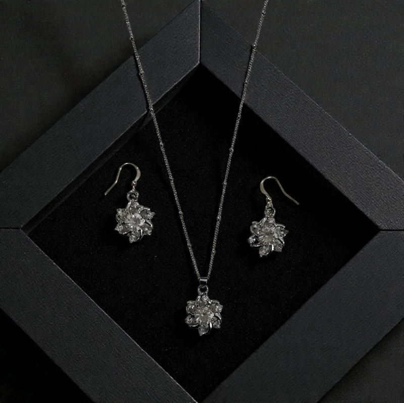 Silver toned floral pendant and matching earings