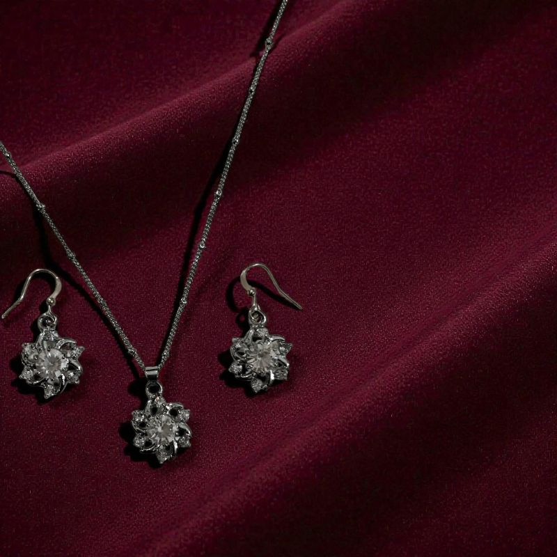 Silver toned floral pendant and matching earings