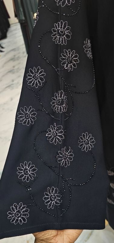 Black Abaya: Flowing Nidha Fabric & Silver Flower Detail