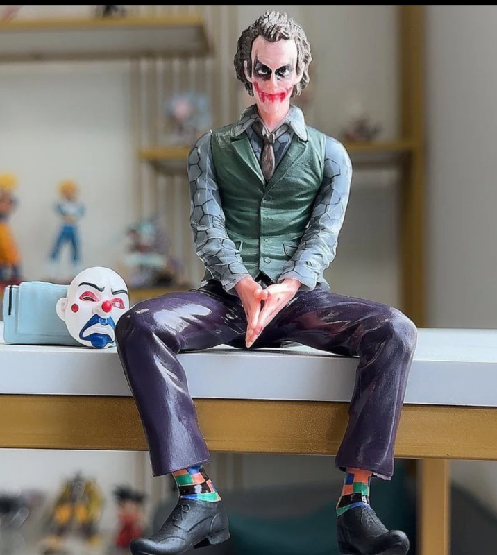 Joker sitting with bag and mask