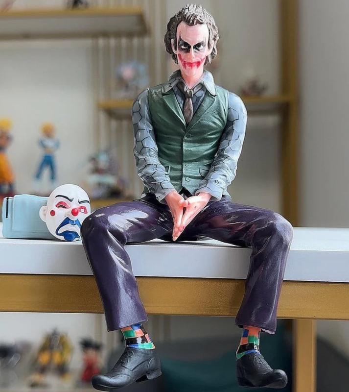 Joker sitting with bag and mask