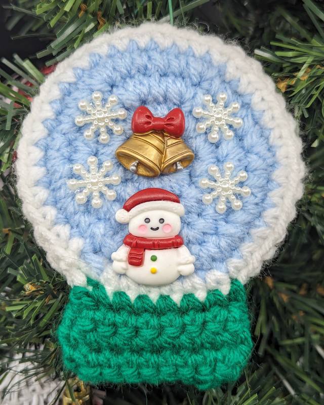 Crochet Snowglobe Ornament (A) - Green base: Red/White Snowman with Golden Bell/Red Bow and 4 Snowflake icons in Globe