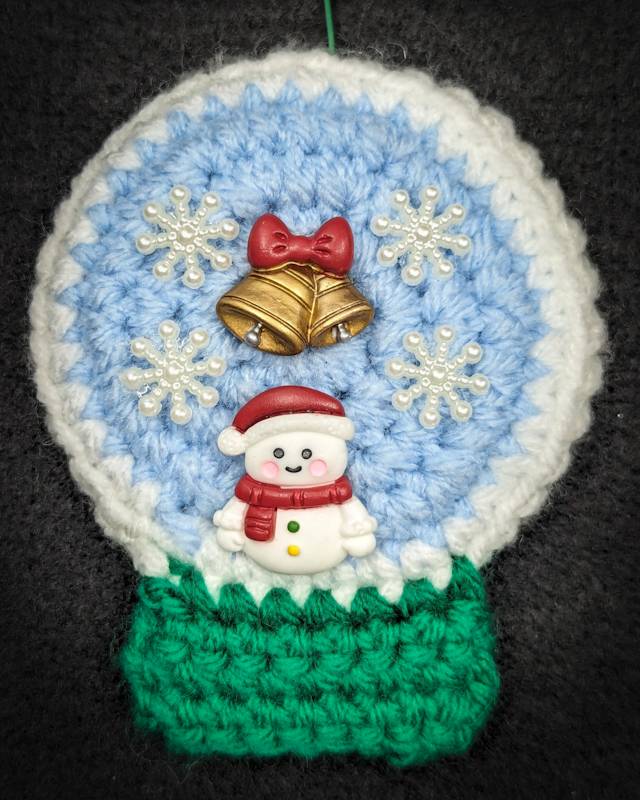 Crochet Snowglobe Ornament (A) - Green base: Red/White Snowman with Golden Bell/Red Bow and 4 Snowflake icons in Globe