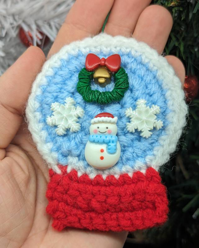 Crochet Snowglobe Ornament (F) - Red base: Green/Red Xmas Wreath and Kawaii Snowman with 2 snowflakes icons in Globe