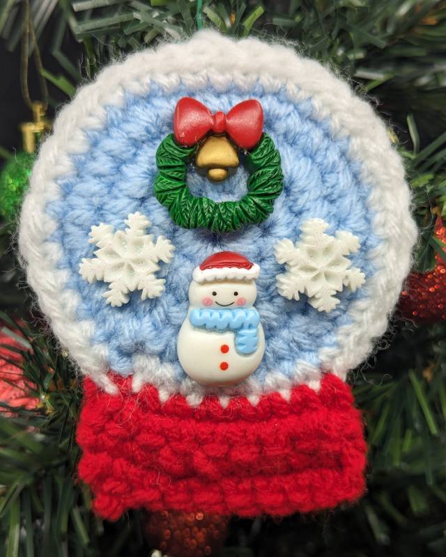 Crochet Snowglobe Ornament (F) - Red base: Green/Red Xmas Wreath and Kawaii Snowman with 2 snowflakes icons in Globe
