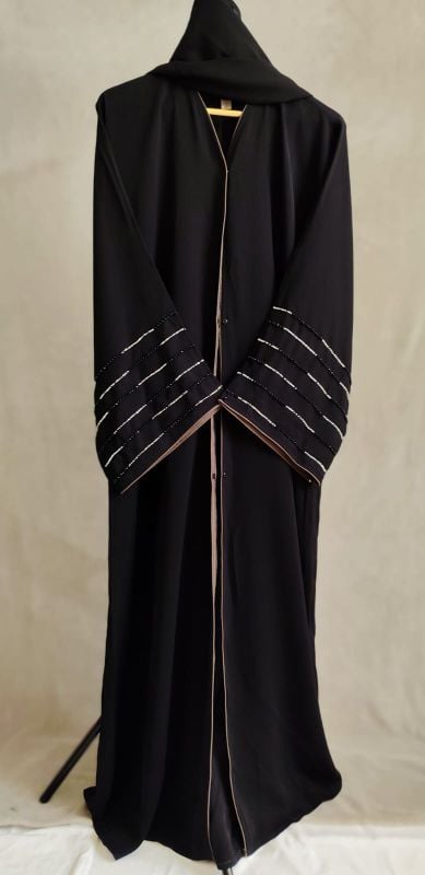 Abaya with front open with buttons and B & W beats work in sleeves