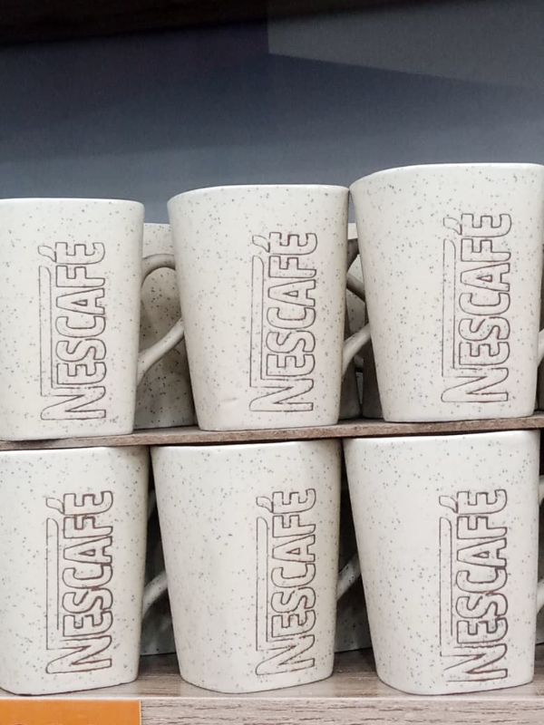 Steaming Nescafe Mug on a Wooden Coaster