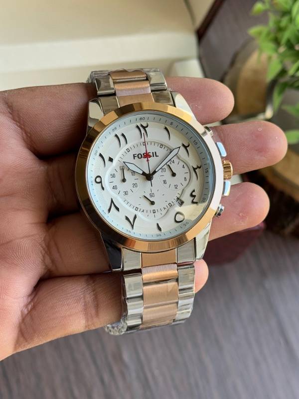 This Fossil watch exudes elegance with its sleek stainless steel design, unique Arabic numeral styling, and sophisticated chronograph functionality.