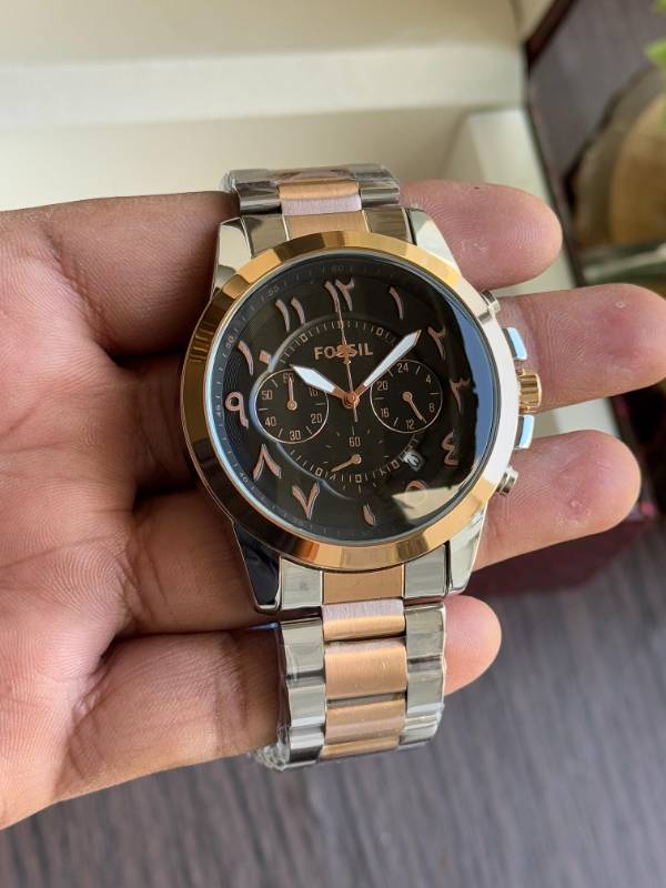 This Fossil watch exudes elegance with its sleek stainless steel design, unique Arabic numeral styling, and sophisticated chronograph functionality.